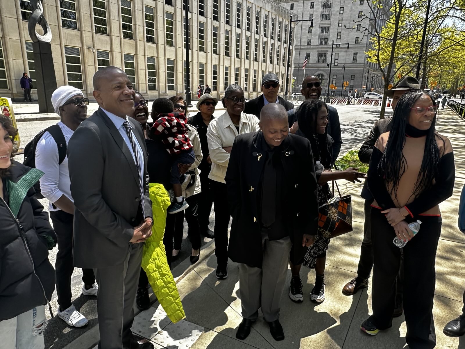 Carlos Watson outdoors with a group of people