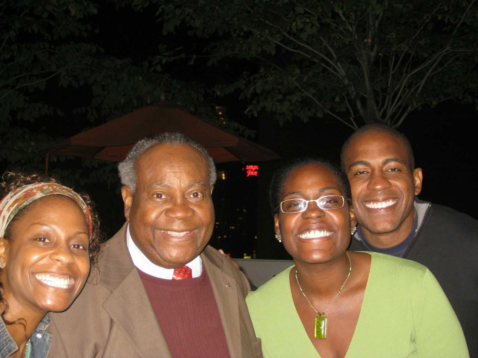Carlos Watson with his father and sisters